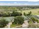 Aerial view of homes with green roofs near golf course at 34841 Double Eagle Ct, Zephyrhills, FL 33541