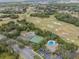 Aerial view shows community amenities including pool, tennis, and golf course at 34841 Double Eagle Ct, Zephyrhills, FL 33541