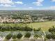 Aerial view of community, highlighting homes and golf course at 34841 Double Eagle Ct, Zephyrhills, FL 33541