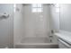 Bright bathroom with a shower/tub combo and white tile at 34841 Double Eagle Ct, Zephyrhills, FL 33541
