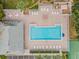 Community pool with surrounding patio and lounge chairs at 34841 Double Eagle Ct, Zephyrhills, FL 33541