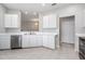 Kitchen with white cabinetry, stainless steel appliances, and tile flooring at 34841 Double Eagle Ct, Zephyrhills, FL 33541