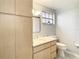 Bathroom with light wood cabinets and a marble countertop at 3604 Rockaway Dr, Holiday, FL 34691
