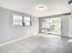 Bright living room with tile floors and sliding glass doors to patio at 3604 Rockaway Dr, Holiday, FL 34691