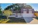 House exterior view: two-story home with a brown roof and a two-car garage at 3604 Rockaway Dr, Holiday, FL 34691