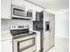Modern kitchen with stainless steel appliances and white cabinets at 3604 Rockaway Dr, Holiday, FL 34691