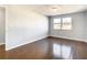 Bedroom with hardwood floors, window, and neutral walls at 3604 Rockaway Dr, Holiday, FL 34691