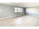 Living room with tile floors, neutral walls and a view to the backyard at 3604 Rockaway Dr, Holiday, FL 34691