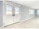 Bright entryway with tile floors and double doors featuring glass panels at 3604 Rockaway Dr, Holiday, FL 34691