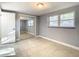 Well-lit bedroom with mirrored closet doors and tile floors at 3604 Rockaway Dr, Holiday, FL 34691