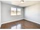 Well-lit bedroom with hardwood floors and a large window at 3604 Rockaway Dr, Holiday, FL 34691
