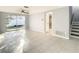 Spacious living area featuring tile floors, sliding glass doors, and a ceiling fan at 3604 Rockaway Dr, Holiday, FL 34691