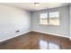 Bedroom with hardwood floors, large window, and neutral walls at 3604 Rockaway Dr, Holiday, FL 34691