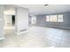 Spacious living area with tile floors, neutral walls, and access to other rooms at 3604 Rockaway Dr, Holiday, FL 34691