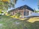 View of home's back and spacious backyard at 3604 Rockaway Dr, Holiday, FL 34691
