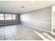 Living room with tile floors, neutral walls, and access to the kitchen at 3604 Rockaway Dr, Holiday, FL 34691