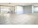 Living room with tile floors, neutral walls, and plenty of natural light at 3604 Rockaway Dr, Holiday, FL 34691