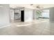 Open concept living room with a view into the kitchen and access to the backyard at 3604 Rockaway Dr, Holiday, FL 34691