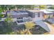 Aerial view of a house with a large yard, showing neighboring houses and a lake at 3604 Rockaway Dr, Holiday, FL 34691