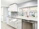 Modern kitchen with white cabinets and granite countertops at 3604 Rockaway Dr, Holiday, FL 34691