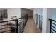 Upper hallway with light wood floors and modern metal railings at 5001 Troydale Rd, Tampa, FL 33615