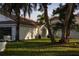 White house with a palm tree-lined lawn at 5001 Troydale Rd, Tampa, FL 33615