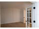 Bright bedroom with hardwood floors and French doors to the bathroom at 5001 Troydale Rd, Tampa, FL 33615