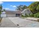 House exterior with solar panels and driveway at 589 59Th S St, St Petersburg, FL 33707