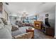 Cozy living room with a fireplace, comfortable seating and a large TV at 589 59Th S St, St Petersburg, FL 33707