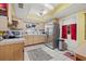 View of a kitchen with stainless steel appliances and wood cabinets at 589 59Th S St, St Petersburg, FL 33707