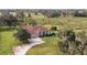 Aerial view of a single-Gathering house with a red tile roof and landscaped yard at 331 Lewis Rd, Lithia, FL 33547