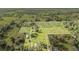 Aerial view of a large property with a house, additional buildings, and cultivated fields at 331 Lewis Rd, Lithia, FL 33547