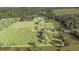 Aerial view of a large property with a house and extensive cultivated fields at 331 Lewis Rd, Lithia, FL 33547