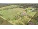 Aerial view of a large property with a house and extensive cultivated fields at 331 Lewis Rd, Lithia, FL 33547