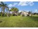 Large backyard with a view of the home and palm trees at 331 Lewis Rd, Lithia, FL 33547