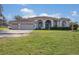 House exterior with three car garage and manicured lawn at 331 Lewis Rd, Lithia, FL 33547