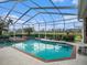 Enclosed, heated pool with spa, surrounded by lush landscaping at 331 Lewis Rd, Lithia, FL 33547
