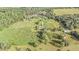 Aerial view of a large property with a house, farmlands, and various outbuildings at 331 Lewis Rd, Lithia, FL 33547