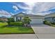 Another view of the charming single story house, showcasing its curb appeal at 7411 Windport Ln, Apollo Beach, FL 33572