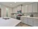 Modern kitchen with stainless steel appliances and an island at 7411 Windport Ln, Apollo Beach, FL 33572