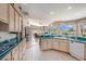 Eat-in kitchen with teal countertops, light wood cabinets, and access to the Gathering room at 331 Lewis Rd, Lithia, FL 33547
