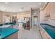 Modern kitchen with light wood cabinets, teal countertops, and stainless steel appliances at 331 Lewis Rd, Lithia, FL 33547