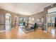 Open living room featuring hardwood floors, neutral walls, and access to a lanai and pool at 331 Lewis Rd, Lithia, FL 33547