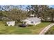 Aerial view of a single story home with detached shed and car at 331 Lewis Rd, Lithia, FL 33547