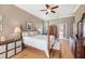 Main bedroom with wood floors, a post bed, and an ensuite bathroom at 331 Lewis Rd, Lithia, FL 33547