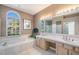 Elegant bathroom with double vanities, a soaking tub, and natural light at 331 Lewis Rd, Lithia, FL 33547
