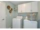 Well-equipped laundry room with washer, dryer, and cabinets at 11294 Linden Depot Rd, San Antonio, FL 33576