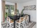 Dining room with black table, white chairs, and access to the backyard at 11294 Linden Depot Rd, San Antonio, FL 33576