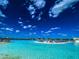 Beach with lounge chairs in a lagoon with blue water and a waterslide at 11294 Linden Depot Rd, San Antonio, FL 33576