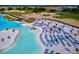 Beach with rows of lounge chairs next to a large lagoon at 11294 Linden Depot Rd, San Antonio, FL 33576